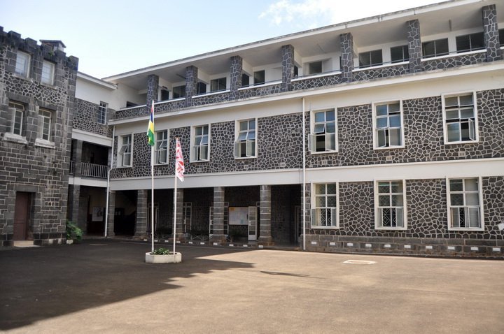 The campus courtyard and stone-faced buildings of Collège du Saint-Esprit in Quatre Bornes, Mauritius.