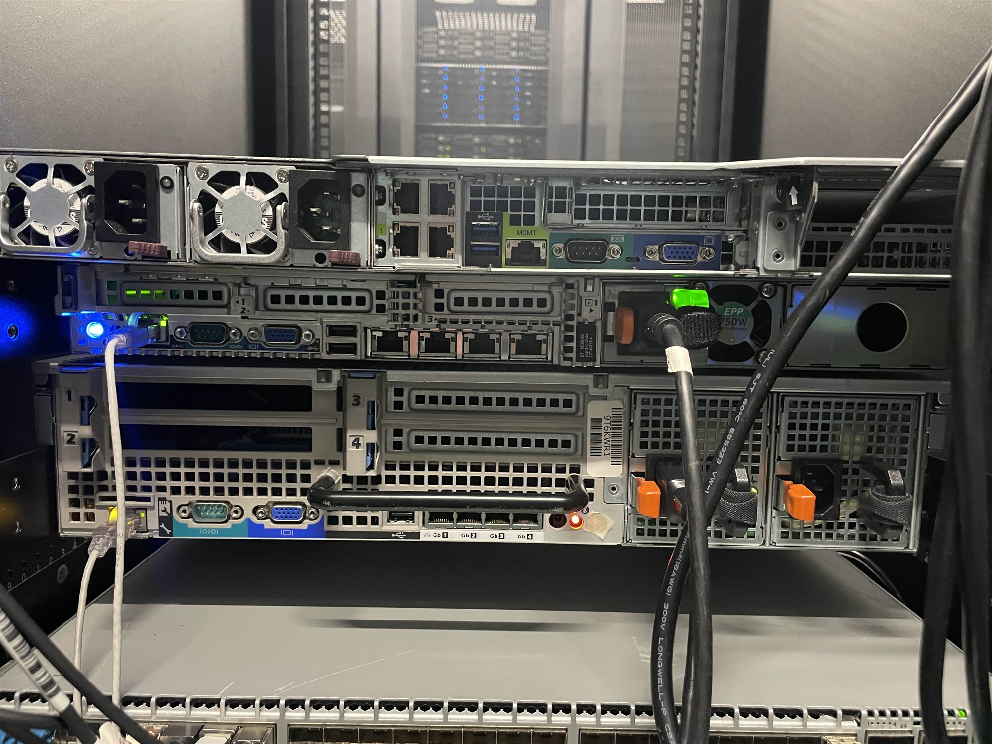 Rear of rack-mounted servers, showing ports, power connections and network cables.